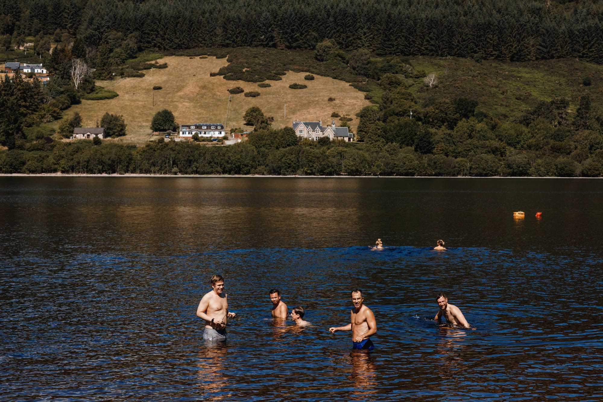 wedding guests in the loch by aldourie castle